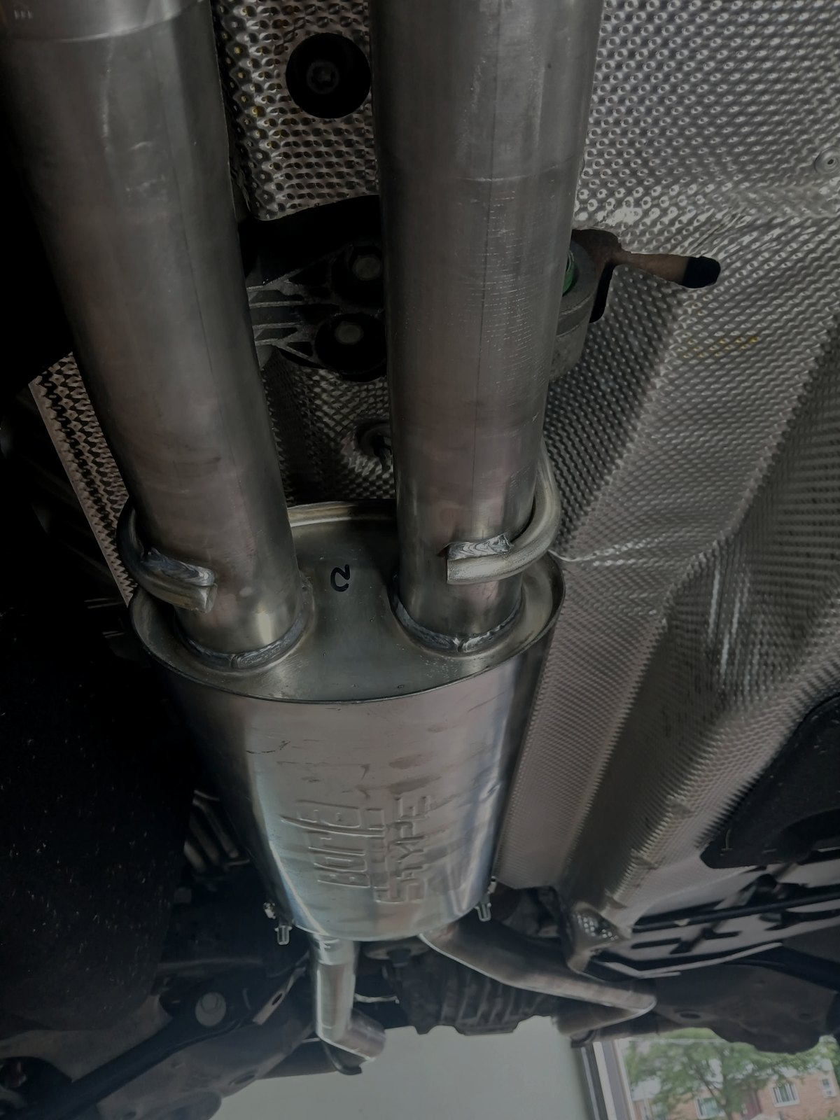 Stainless exhaust piping and muffler installed under a vehicle